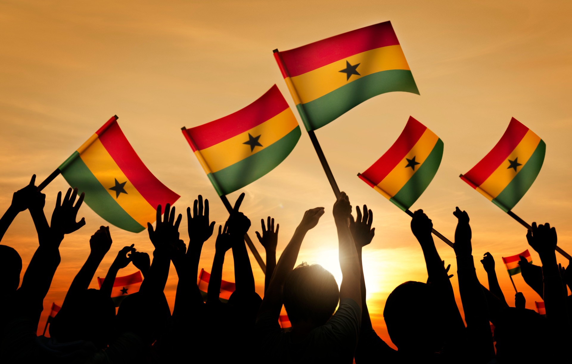 Group of People Waving the Flag of Ghana